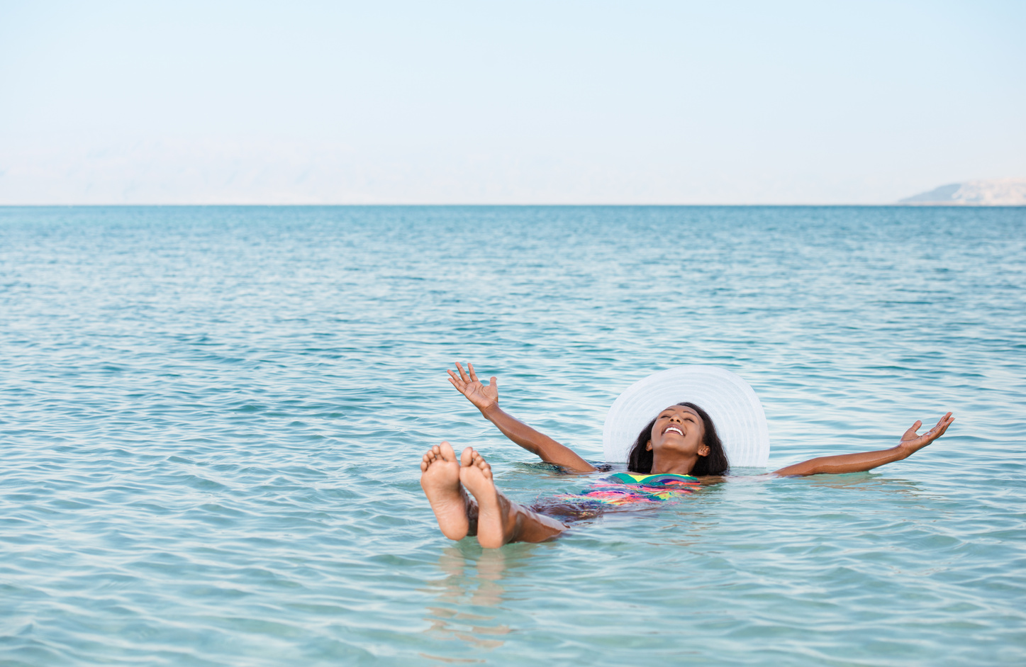 Woman floating in Dead Sea.